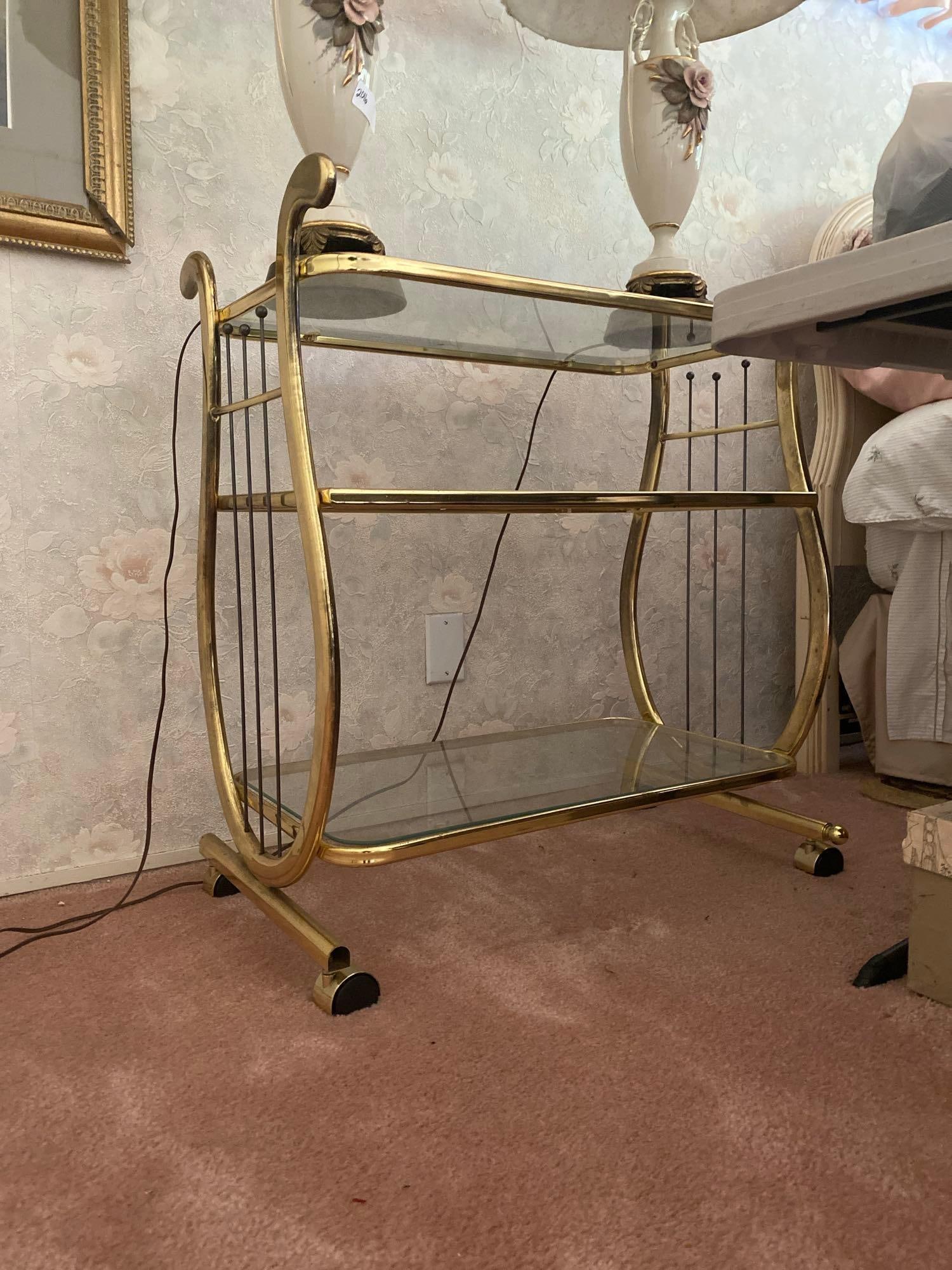 Hollywood Regency Glass & Brass Three Tiered Cart.: no shipping available for this item. Local pick up only. Hollywood Regency glass & brass Three tiered cart. Approximately 32.0h x 28.5w x 18.0d in.
