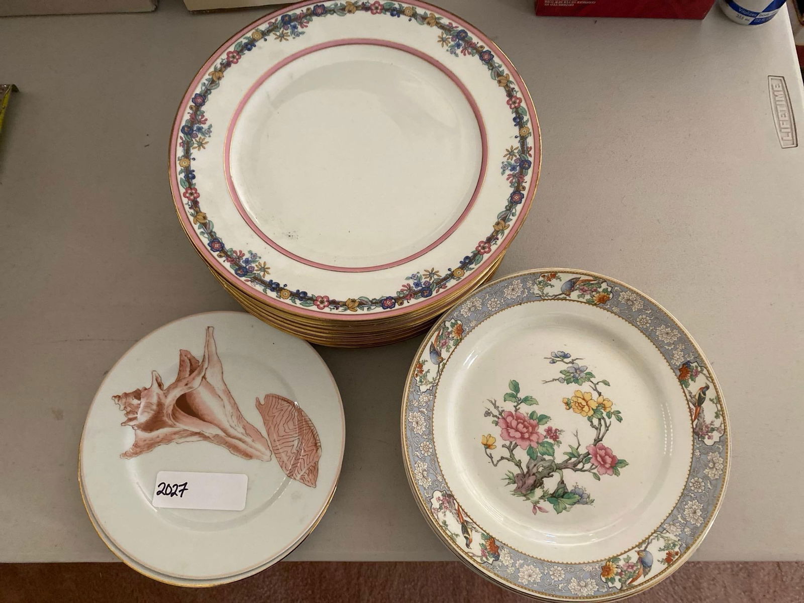 Grouping Of Porcelain Plates: Grouping of porcelain plates including 10 G. Ahrenfeldt Limoges dinner plates, 7 Johnson Brothers "The Vigo" plates, and more.