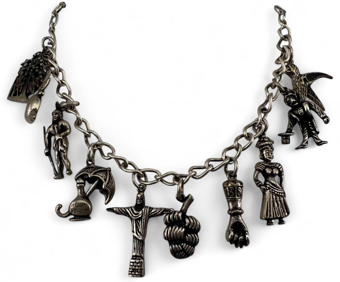 Silver Brazil Charm Bracelet: Silver Brazil Charm Bracelet, 43.0g. Unmarked, tests as 83 percent silver. Bracelet length approximately 8.0in. Largest charm approximately 25.5 x 15.2mm. Smallest approximately 20.5 x 11.5mm.