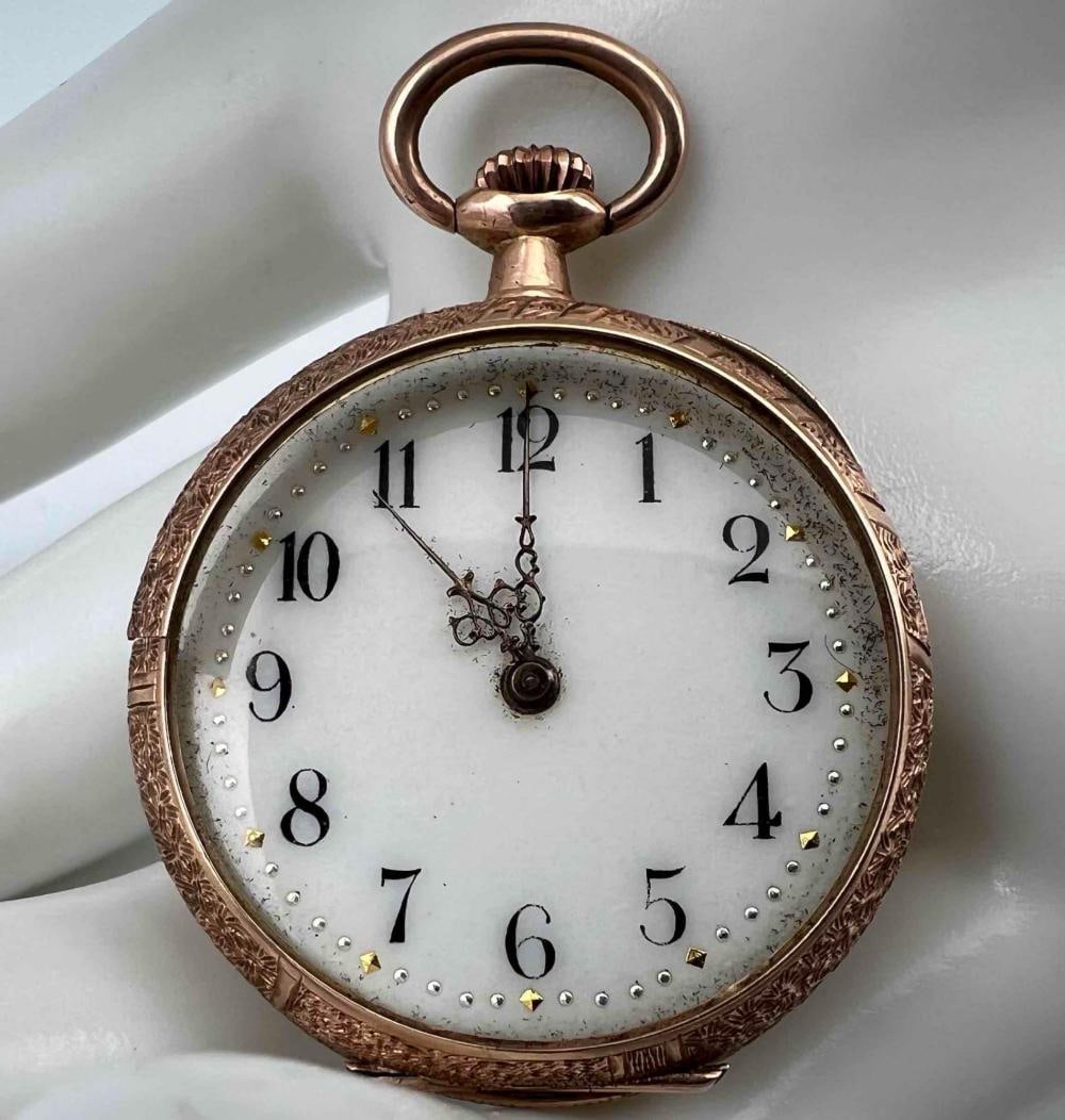 12K Gold Ladies Pocket Watch With Etched Iris Motif: 12K Gold Ladies Pocket Watch With Etched Iris Motif. Inner cases marked "K12 27166." Approximately 40.7H x 28.9W mm. Face approximately 24.0mm. Missing crystal. Not running. Please note break in front