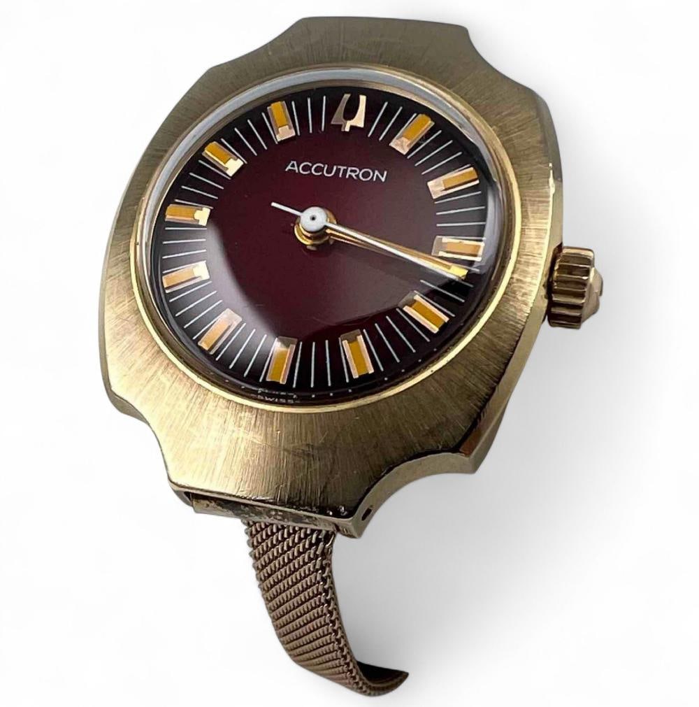 Vintage 14K Bulova Accutron Wrist Watch: Vintage 14K Bulova Accutron Wrist Watch. Marked "Bulova N2 H31590 14KT Gold Case." Gold filled band marked "Hadley 1/20 10K GF." Case approximately 24.0mm. Face approximately 19.0mm. Maximum inner cir