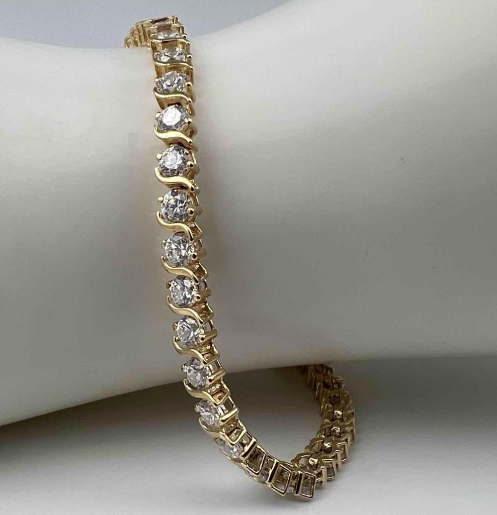 14K Yellow Gold CZ Tennis Bracelet: 14K Yellow Gold CZ Tennis Bracelet, 9.0g. Marked 14K. Inner circumference approximately 8.25in. Width approximately 3.5mm. ALL CREDIT CARDS WILL BE MANUALLY VERIFIED PRIOR TO SHIPMENT.