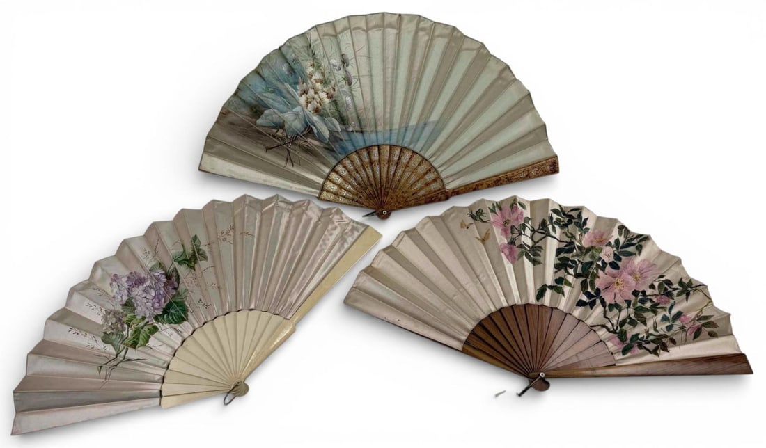Three Antique Hand Painted Silk Fans With Floral Designs: Three Antique Hand Painted Silk Fans With Floral Designs. Largest (with bone sticks and guards) approximately 23.5W x 12.75H in. Guards approximately 12.75L x 1.125W in. Smallest approximately 22.875W