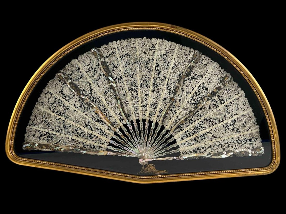 Mother Of Pearl & Lace Fan In Shadowbox Frame: Parcel Gilt Mother Of Pearl & Lace Fan In Shadowbox Frame, 19th Century. As framed approximately 29.0W x 17.0H x 2.0D in. Fan approximately 26.0W x 13.5H in. Each stick approximately 13.5in. Fan has n
