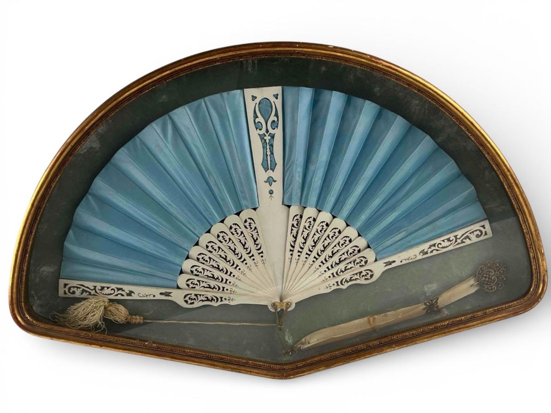 19th Century Blue Silk Fan In Shadowbox Frame: 19th Century Blue Silk Fan In Shadowbox Frame. Lacquered wood sticks & guards. As framed approximately 24.25W x 15.125H x 2.0D in. Fan approximately 20.0W x 10.0H in.
