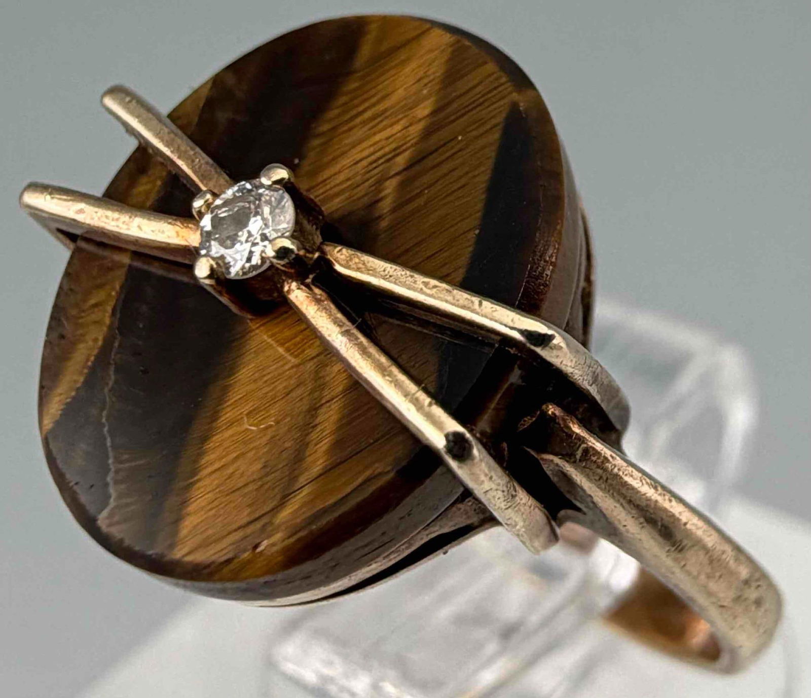 10K Tiger's Eye & Diamond Ring: 10K Tiger's Eye & Diamond Ring, 2.2g. Marked 10K. Ring front approximately 11.9 x 11.7mm. Approximate ring size 4.5. Please note that tiger's eye stone is loose in setting. Weight without tiger's eye