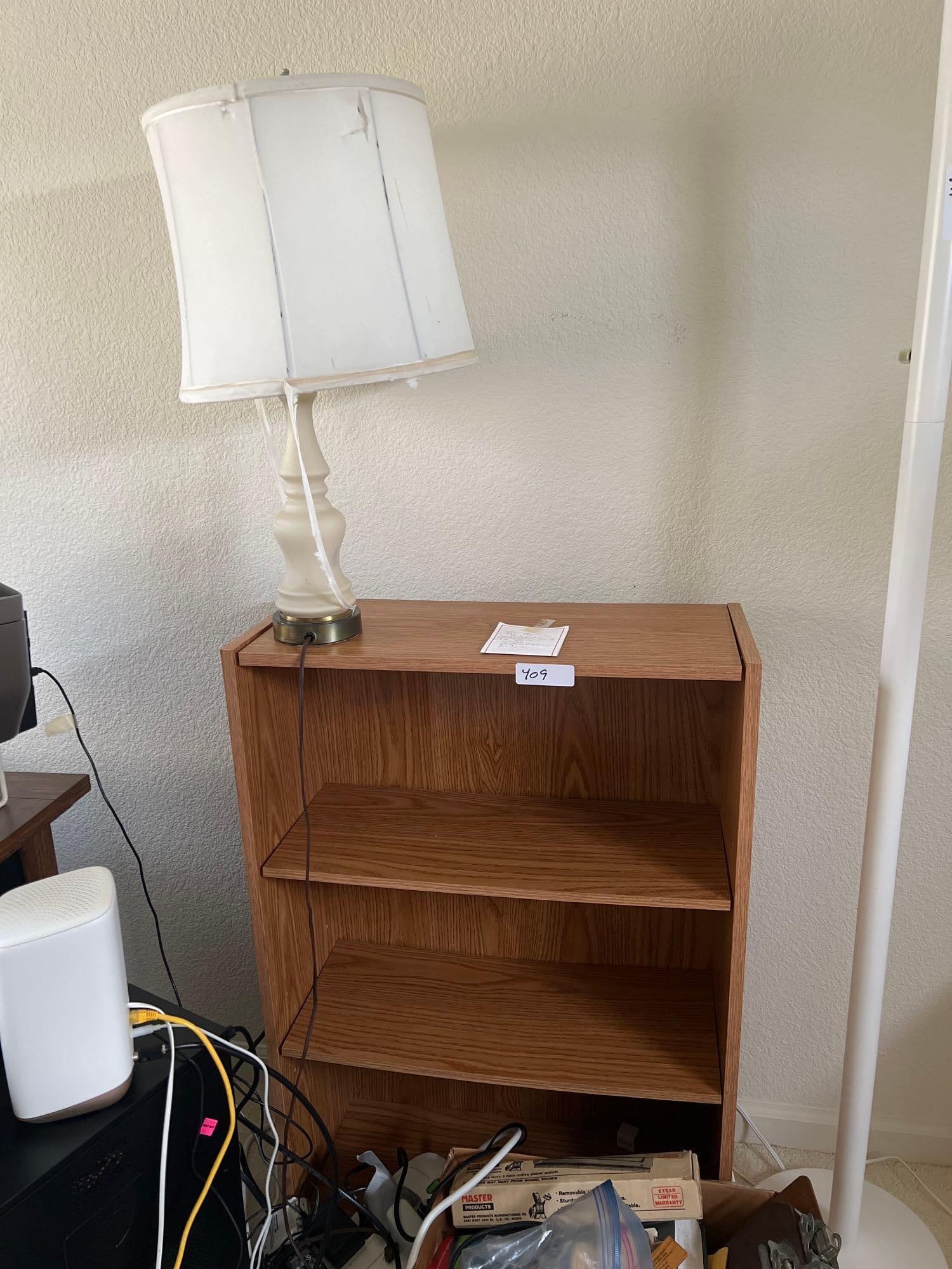 Four Tiered Bookshelf And Lamp: Four tiered bookshelf and lamp.