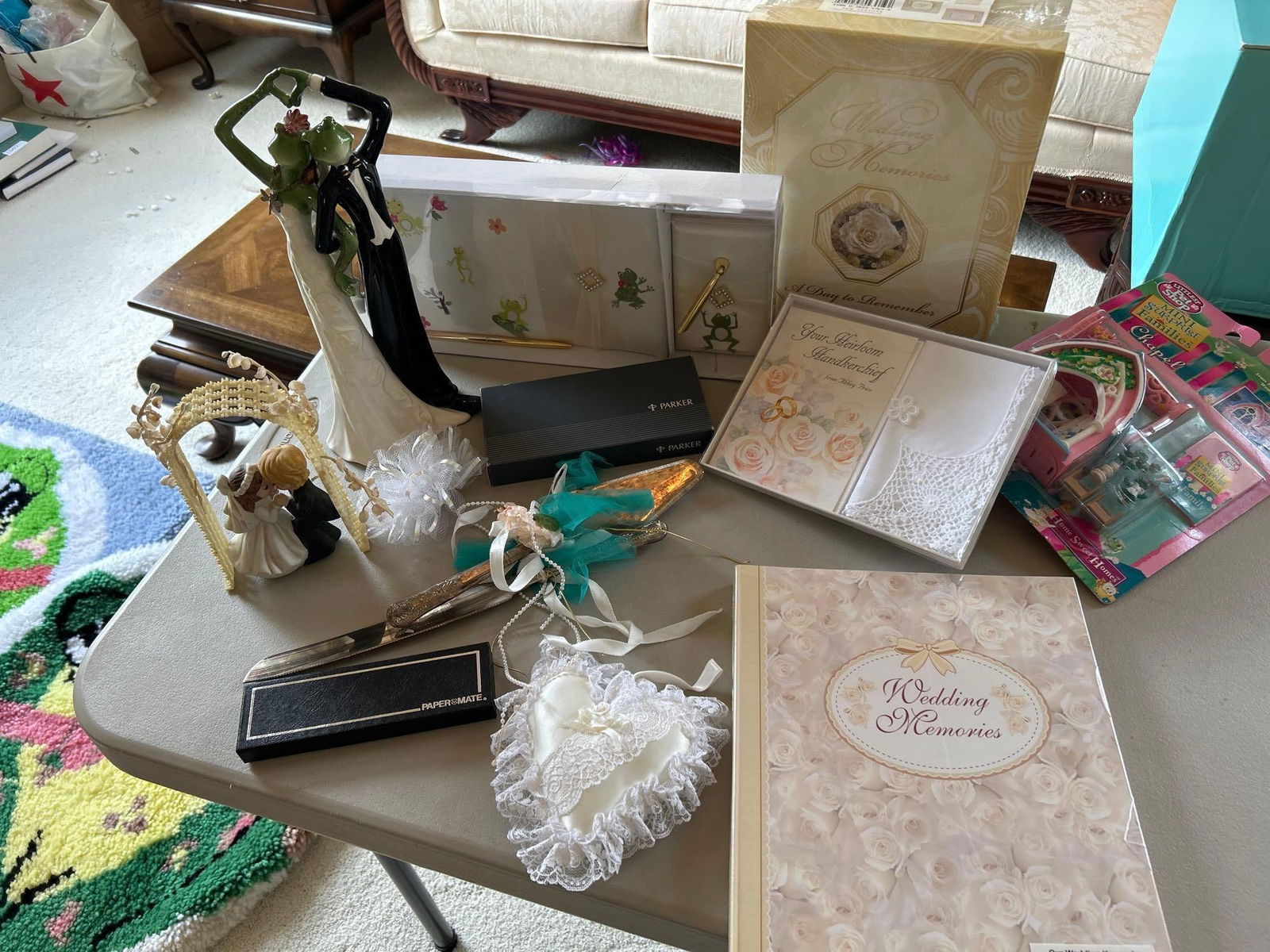 Box Of Wedding Related Items, Including Appletree Designs Frog Figure: Box of wedding related items, including Appletree Designs frog figure. Also includes pen set, cake topper, cake server, cake knife, and more.