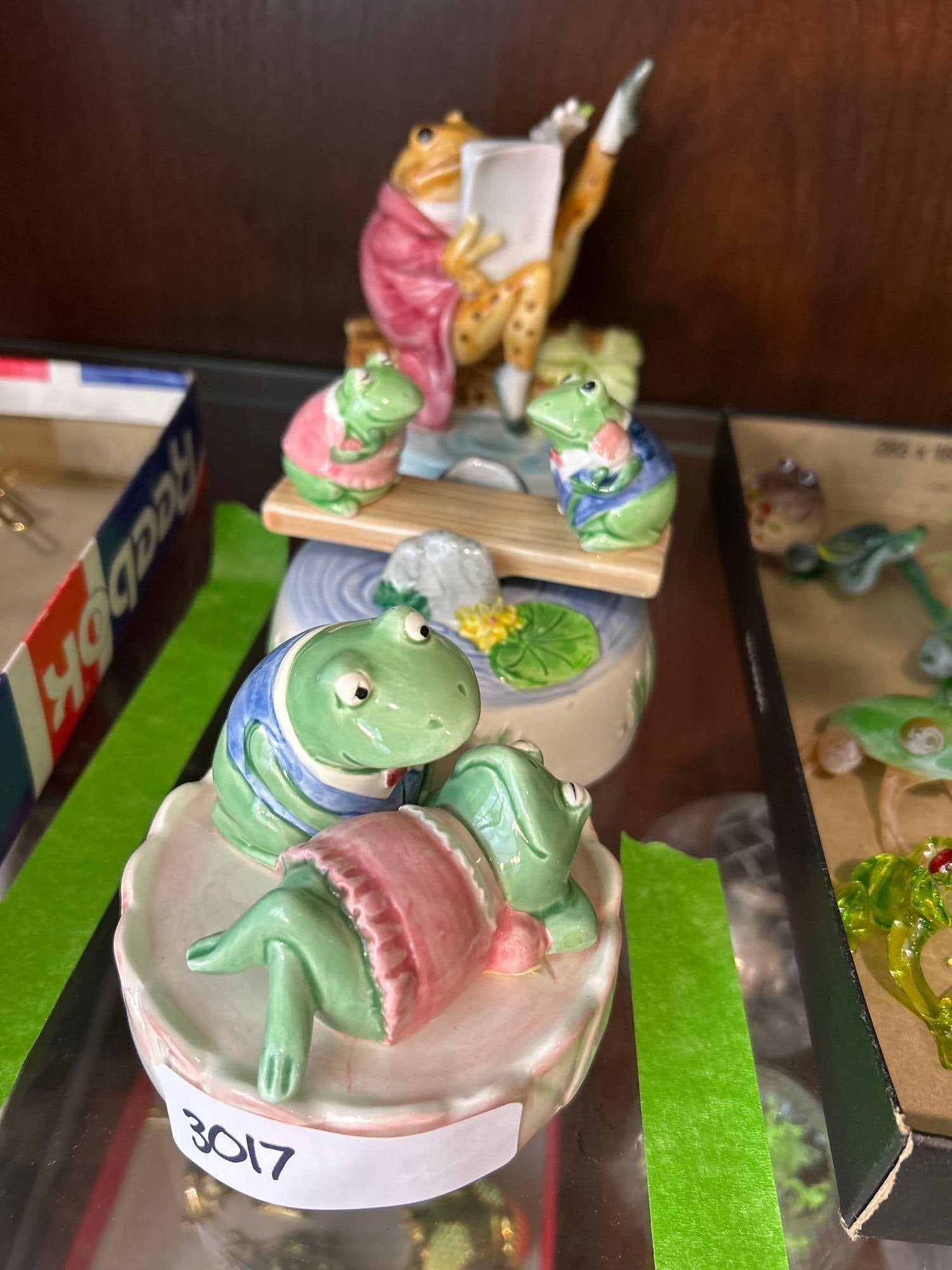 Three Porcelain Frog Themed Music Boxes: Three porcelain frog themed music boxes. Largest (Beatrix Potter) approximately 6.25H x 4.5W in.