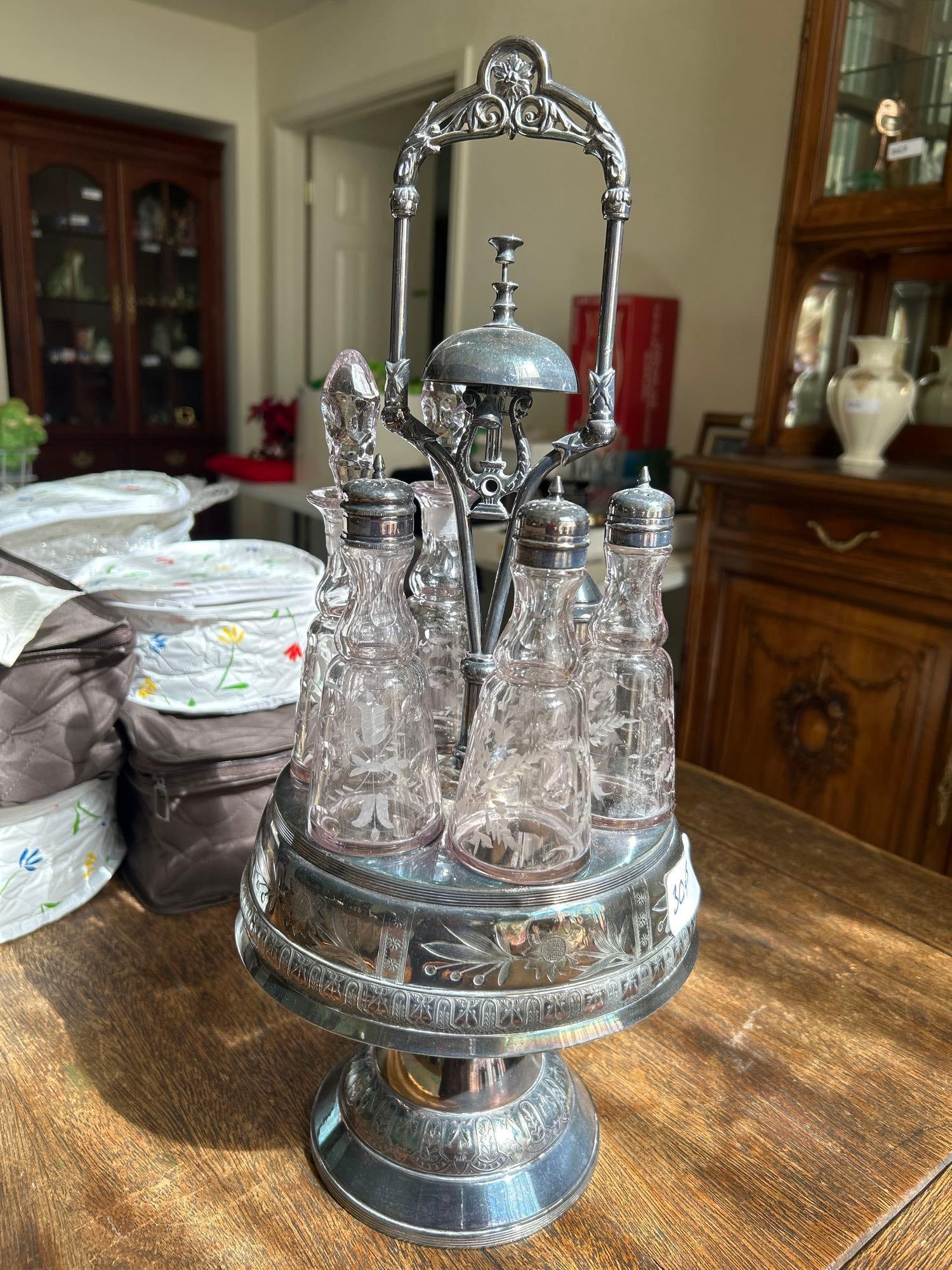Antique Victorian Silver Plate Cruet Set With Six Etched Glass Bottles: Antique Victorian silver plate cruet set with six etched glass bottles. Glass is starting to turn slightly purple.