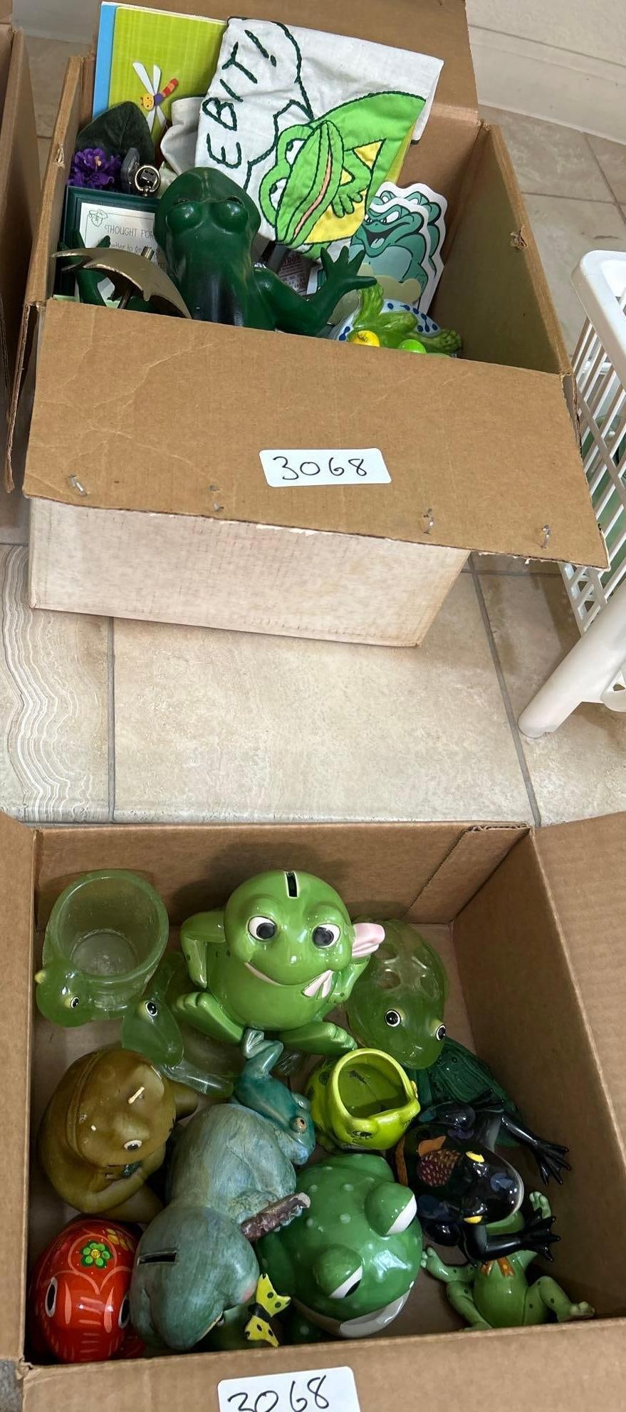 Two Boxes Of Frog-Themed Collectibles: Two boxes of frog-themed collectibles.