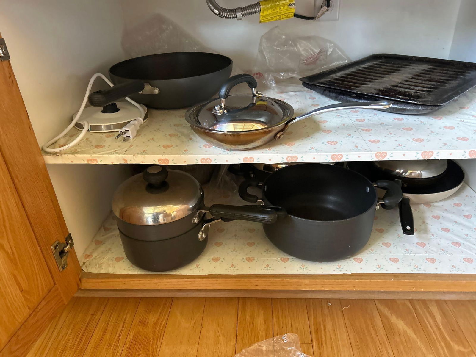 Cupboard Of Miscellaneous Pots And Pans: Cupboard of miscellaneous pots and pans.