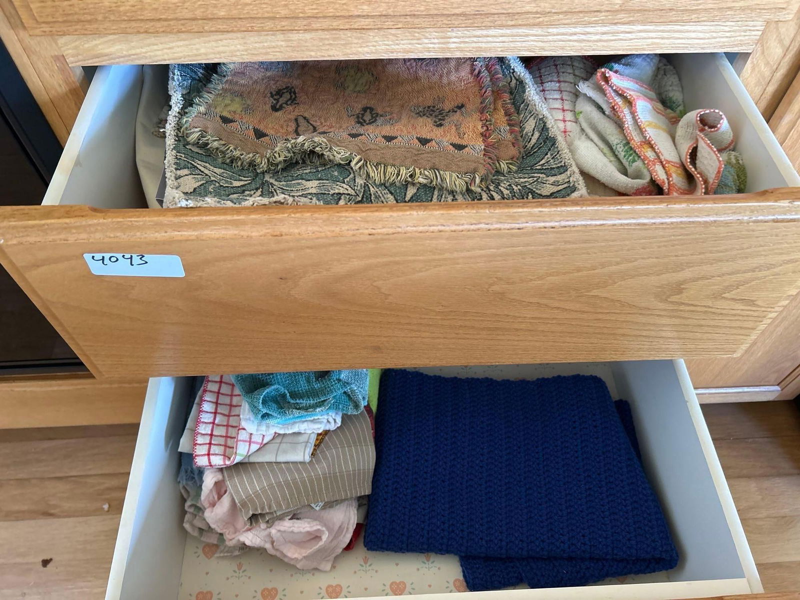 Two Drawers Of Kitchen Linens: Two drawers of kitchen linens.