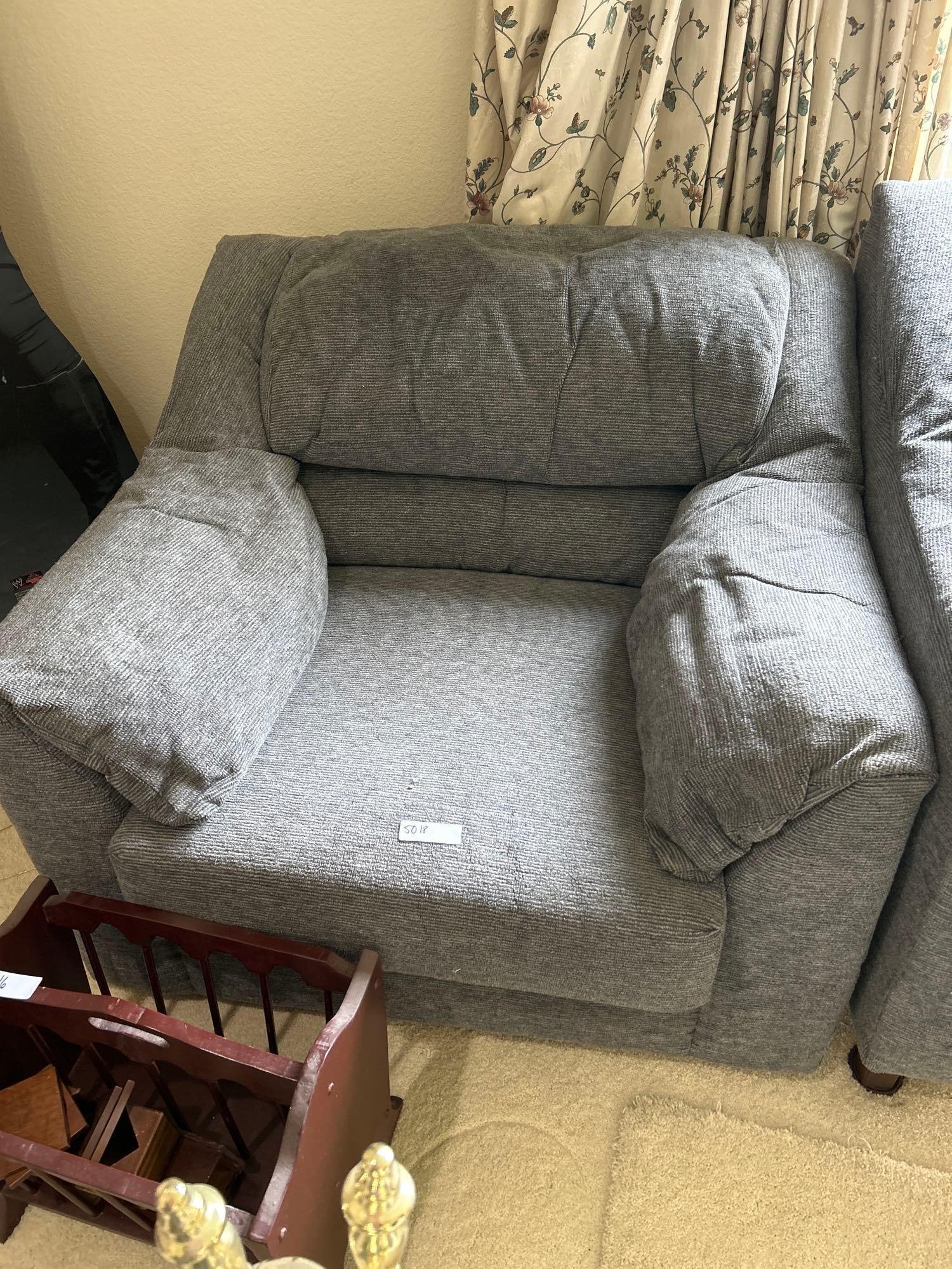 Grey Upholstered Arm Chair: Grey upholstered arm chair. Cushions on chair make crinkly sound when you touch them.