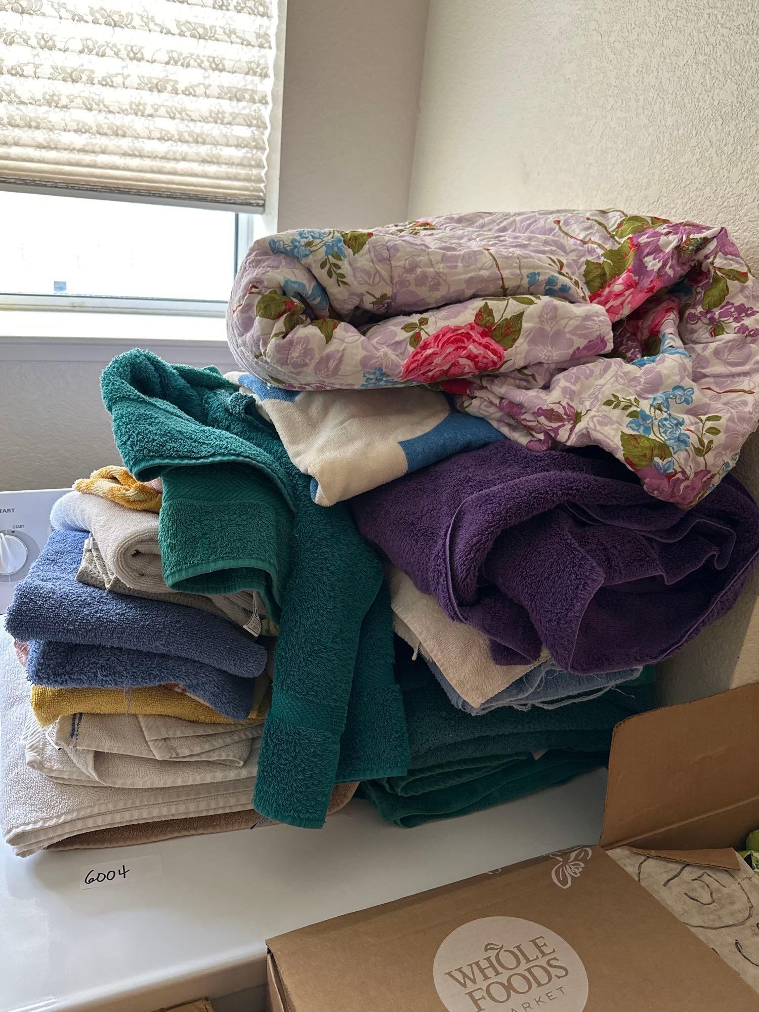 Towels And Floral Quilt: Towels and floral quilt.