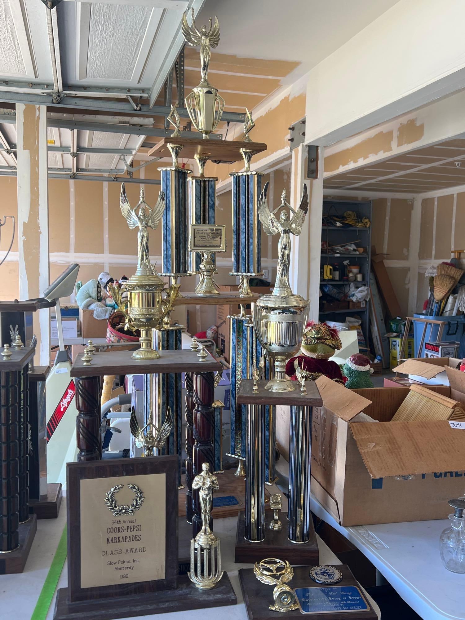 Grouping Of Vintage Car Trophies: Grouping of vintage car trophies. Largest approximately 50.0in high.