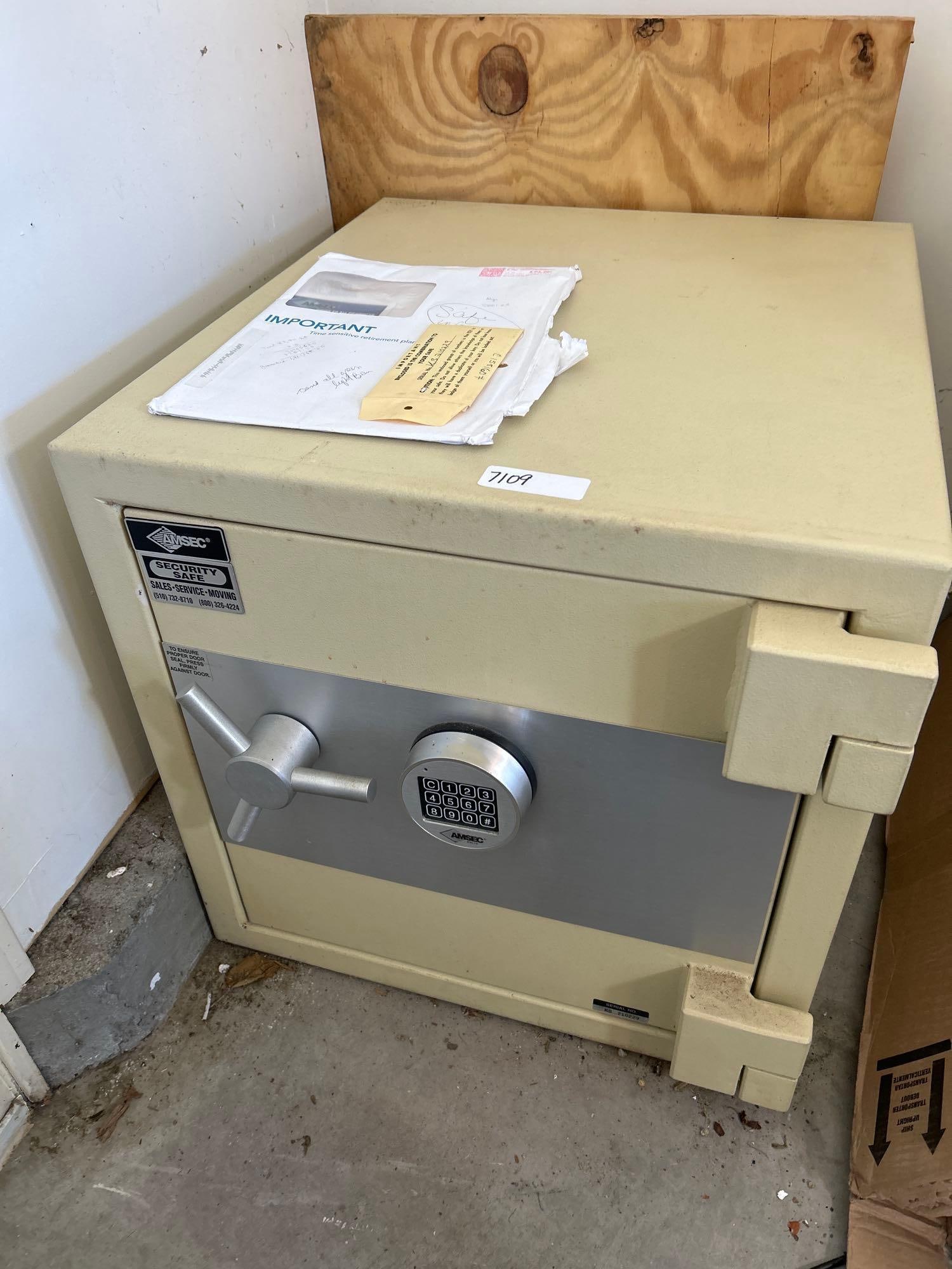 Amsec Safe: Amsec Safe. In working order with combination and paperwork. Approximately 23.0H x 23.0W x 26.25D in. Please note that piece is bolted to the floor and will need to be removed.