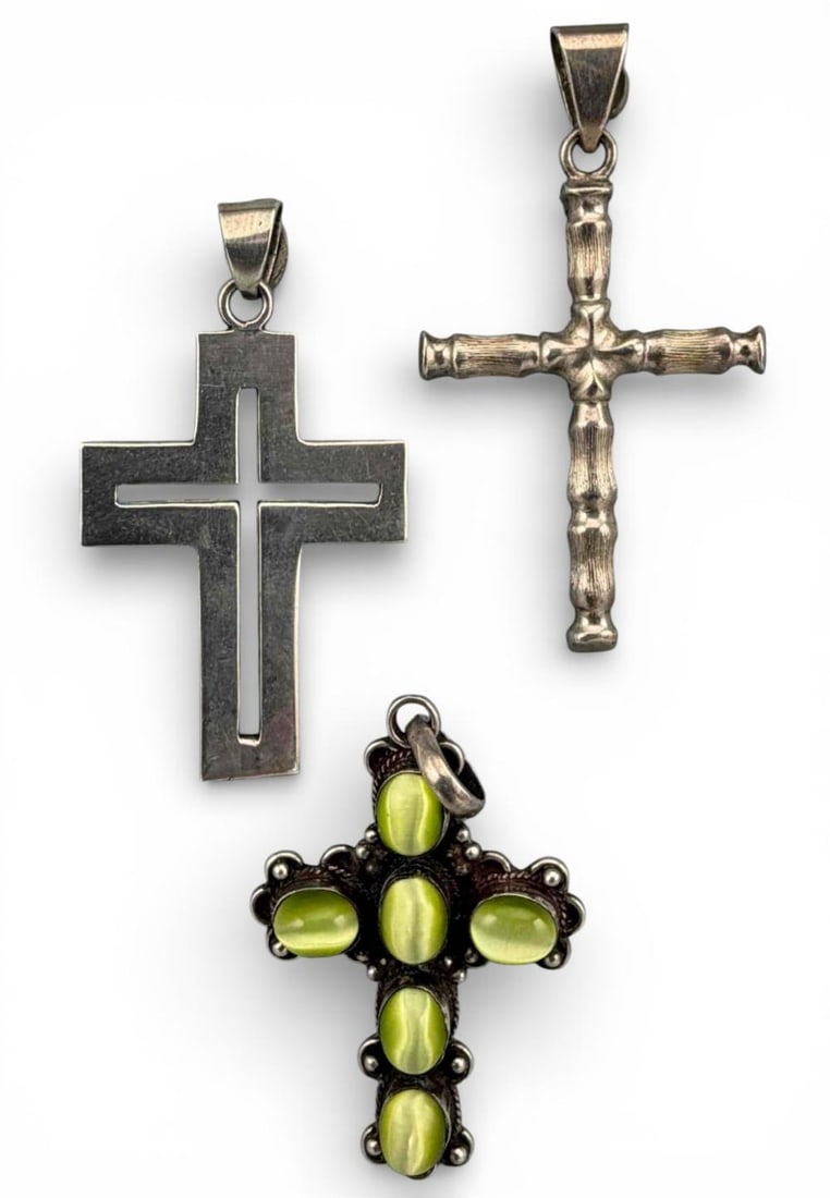 Three Vintage Mexican Sterling Silver Cross Pendants: Three Vintage Mexican Sterling Silver Cross Pendants, 40.5g. Two marked "925 Mexico," one marked "925." Cat's eye pendant approximately 2.38L x 1.39W in. Cross with open center approximately 2.32L x