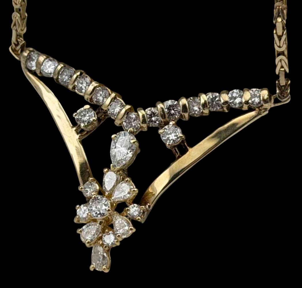 14K Gold Diamond Pendant Necklace, 2.71 Ctw: 14K Yellow Gold Diamond Necklace, 15.9g. Total estimated diamond weight 2.71 carats. Features a V-form pendant set with round and pear-shaped diamonds arranged in a cascading cluster design,