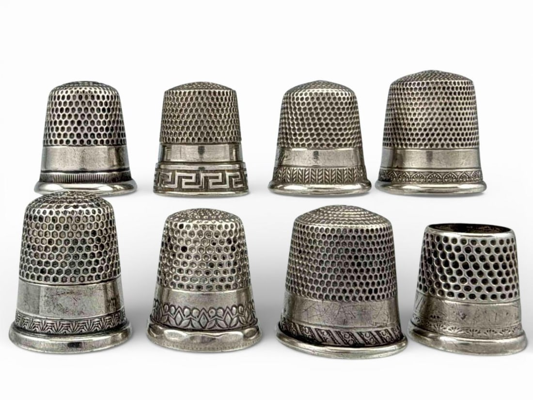 Eight Sterling Silver Thimbles: Eight Sterling Silver Thimbles, 27.8g. Marked test as sterling. Largest approximately 21.3 x 18.1mm. Smallest approximately 16.1 x 15.8mm. Provenance: From the private collection of Joel Rothschild.