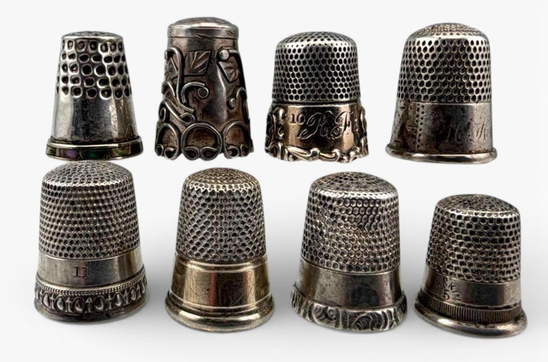 Grouping Of Eight Sterling Silver Thimbles: Grouping Of Eight Sterling Silver Thimbles, 35.4g. Marked or test as sterling. Largest approximately 23.5 x 17.4mm. Smallest approximately 17.8 x 15.4mm. ALL CREDIT CARDS WILL BE MANUALLY VERIFIED PRI