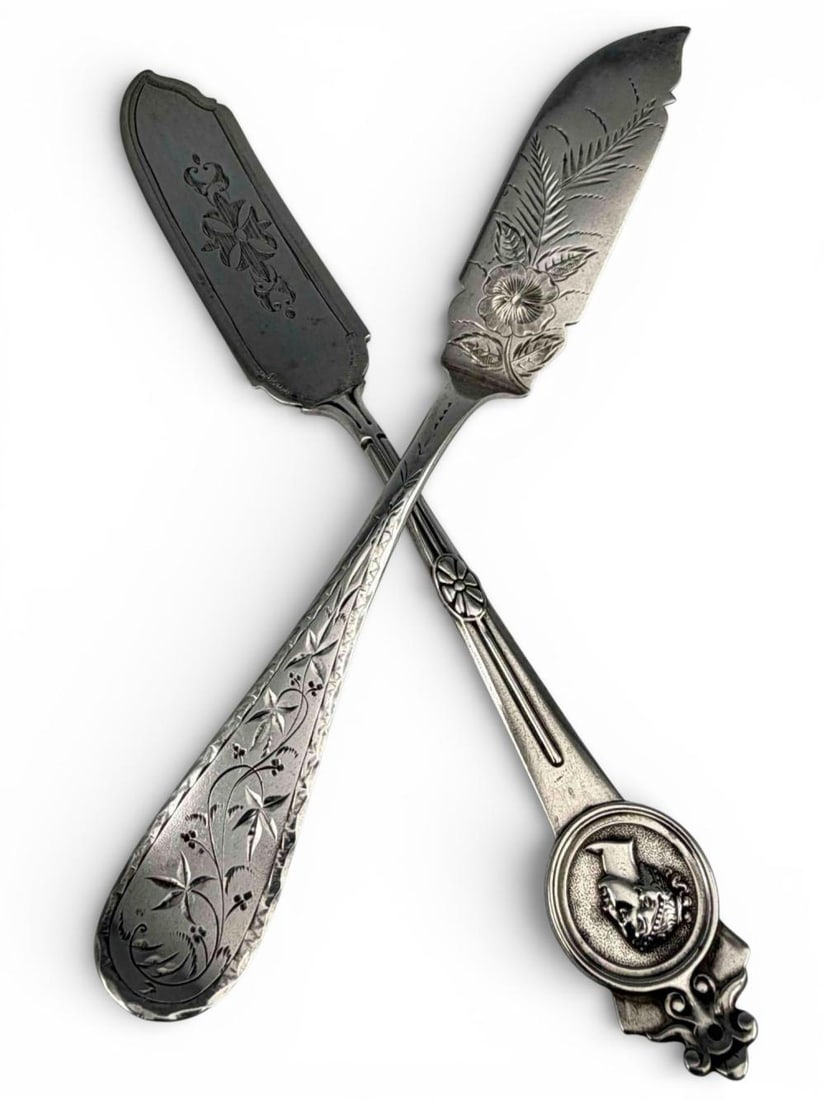 Two 19th Century Sterling Silver Master Butter Knives: Two 19th Century Sterling Silver Master Butter Knives, 68.8g. Includes Gorham Medallion pattern, and Ranger & Thompson. Marked "Sterling." Gorham piece approximately 7.625L x 0.875W in. Ranger & Thomp