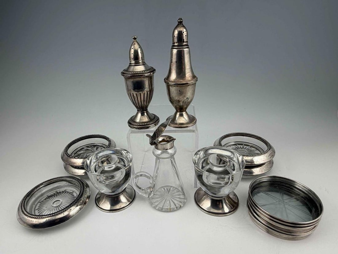 Grouping Of Sterling Silver Tableware: Grouping Of Sterling Silver Tableware. Marked "Sterling." Candlesticks approximately 2.75H x 2.625W in. Larger coasters approximately 3.875W x 1.0H in. ALL CREDIT CARDS WILL BE MANUALLY VERIFIED