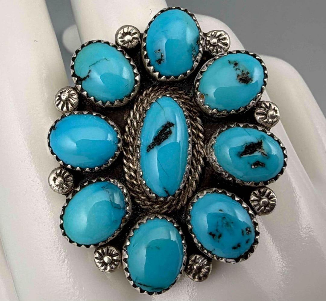 Navajo Sterling Silver Turquoise Ring: Navajo Sterling Silver Turquoise Ring, 13.2g. Marked illegibly, tests as sterling. Ring front approximately 1.57 x 1.31in. Center turquoise piece approximately 13.6 x 6.2mm. Approximate ring size 11.