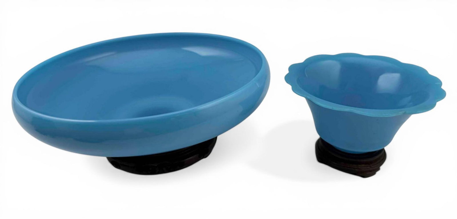 Two Chinese Turquoise Peking Glass Bowls: Two Chinese Turquoise Peking Glass Bowls. Larger approximately 8.875W x 2.75H in. Smaller approximately 4.875W x 2.5H in. Measurements exclude wood stands. Please note that winning bidders are not req