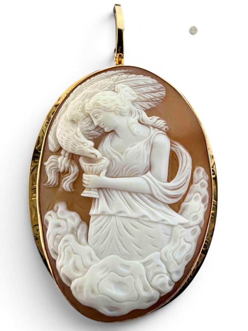 Large 10K Mounted Cameo Pendant, Hebe Feeding Zeus's Eagle: Large 10K Mounted Cameo Pendant, Hebe Feeding Zeus's Eagle. Mounting unmarked, tests as 10K. Later bale marked "Stuller," tests as gold plate. Back of cameo signed illegibly. Pendant approximately 2.1
