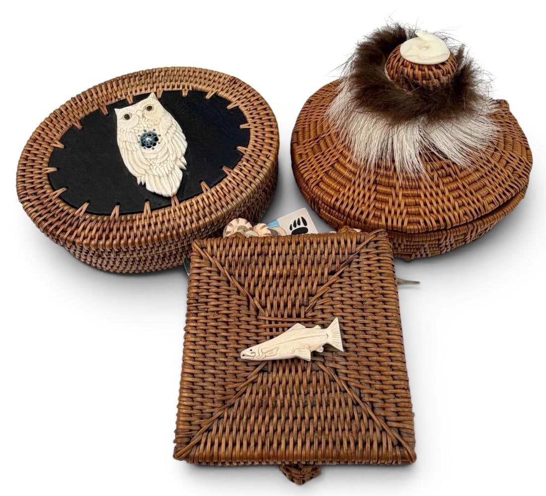 Three Alaskan Smoked Grass Baskets: Three Alaskan Smoked Grass Baskets. Tag attached to largest basket reads "Handwoven 5" round smoked grass basket with lid enhanced with carved bone salmon, caribou, beaver fur + recycled glass + bone