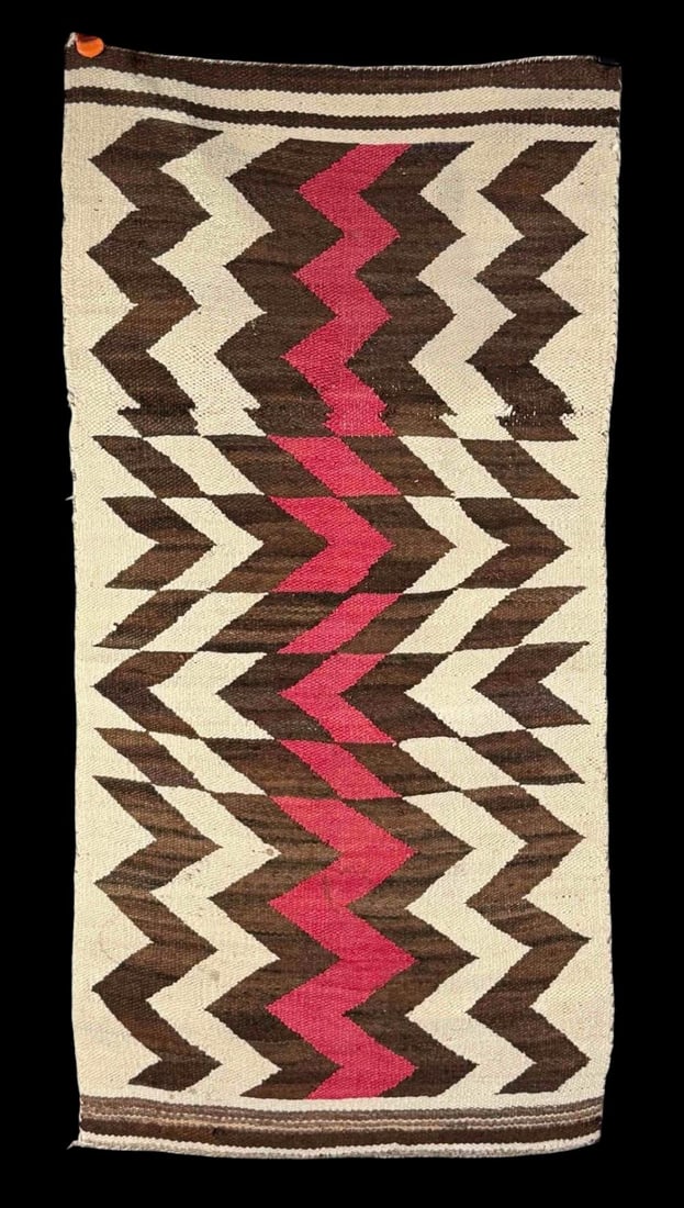 Navajo Rug, Early 20th C.: Navajo Rug, Early 20th C. Features a geometric zigzag pattern in dark brown, cream, and central red accents. The design is arranged in strong vertical bands with striped borders at the top and