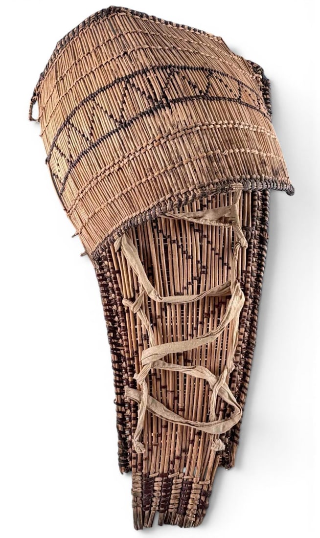 Native American Basketry Cradleboard: Native American Basketry Cradleboard With Geometric Pattern And Cloth Straps. Approximately 19.37L x 9.5W x 7.25D in.