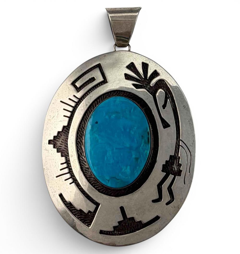 Native American Sterling Silver Turquoise Kokopelli Pendant: Native American Sterling Silver Turquoise Kokopelli Pendant, 25.3g. Signed "CB." Marked "Sterling." Approximately 2.44L x 1.89W in. Length with bale approximately 3.0in. Turquoise piece approximately 
