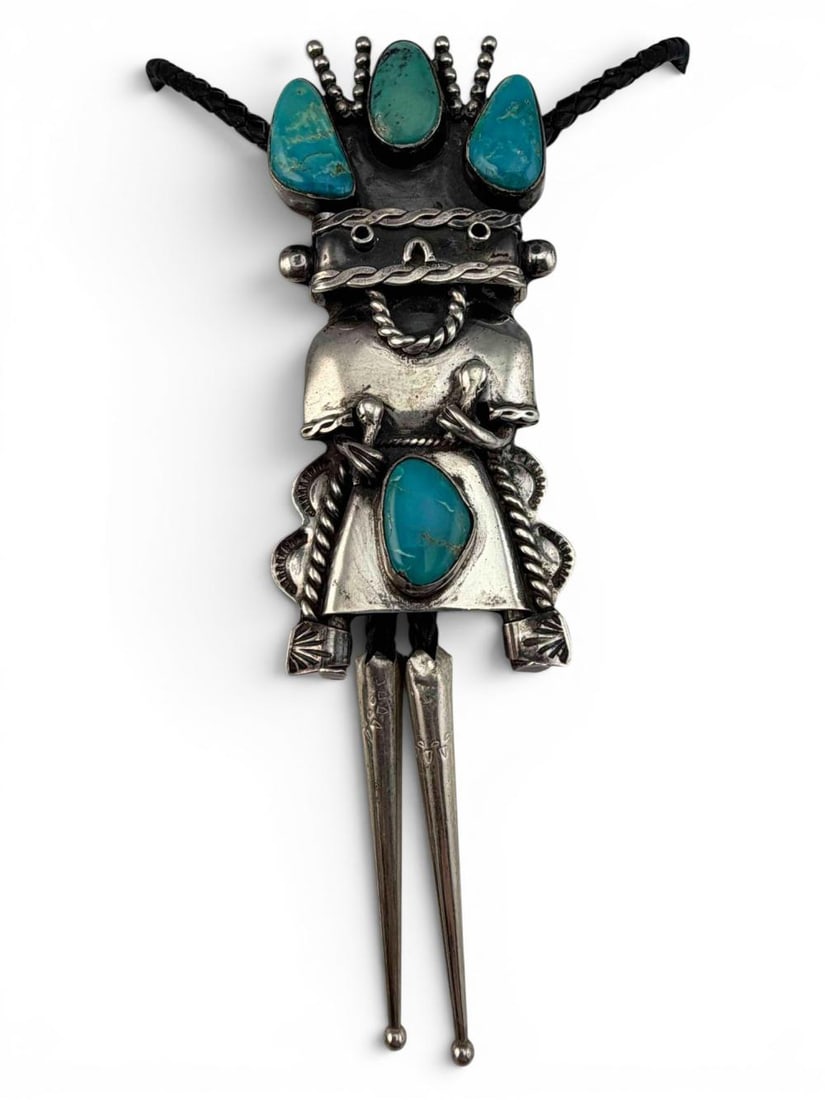 Navajo Sterling Silver Turquoise Figural Kachina Bolo Tie: Navajo Sterling Silver Turquoise Figural Kachina Bolo Tie. Total weight 63.5g. Signed "FB." Bolo and tips test as sterling. Bolo approximately 3.56L x 1.53W in. Largest turquoise piece approximately 0