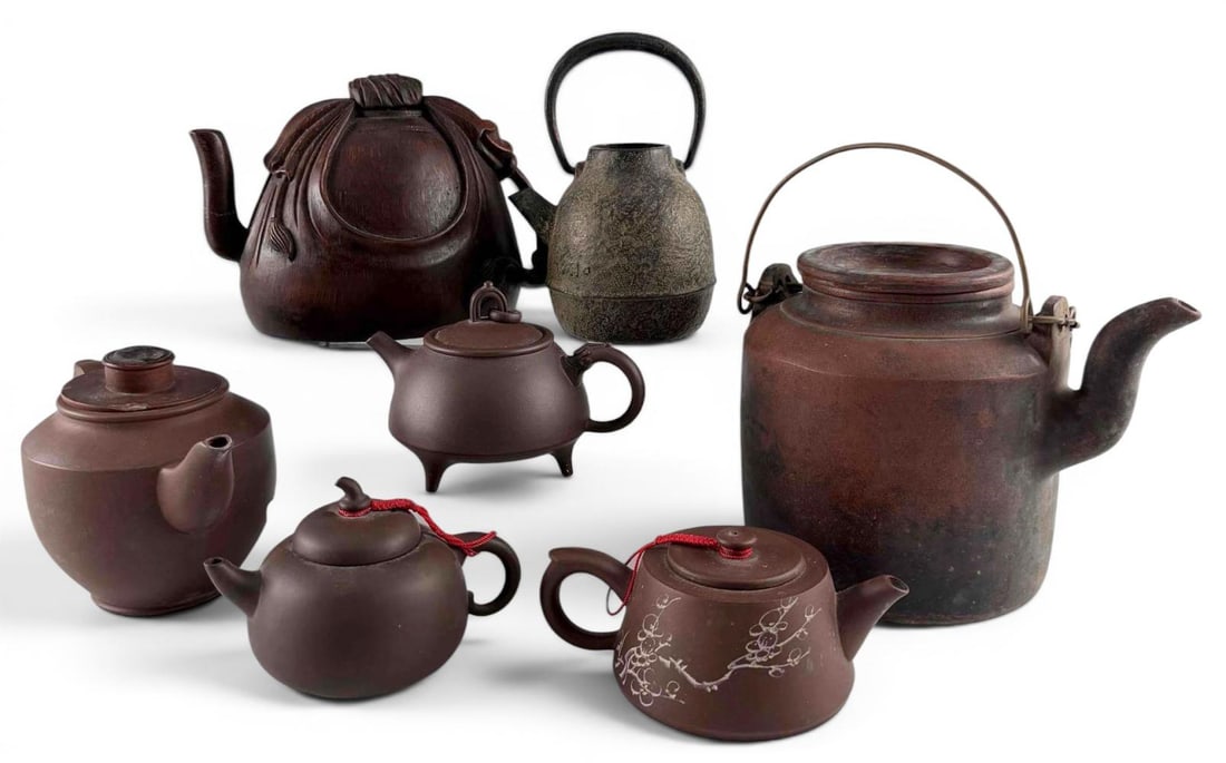 Grouping Of Asian Teapots, Including Yixing Clay, Iron, And Carved Bamboo: Grouping Of Asian Teapots, Including Yixing Clay, Iron, And Carved Bamboo. Largest approximately 5.62H x 7.25L x 5.5W in. Bamboo teapot approximately 4.87H x 6.75L x 4.0W in. (Please note repair to sp