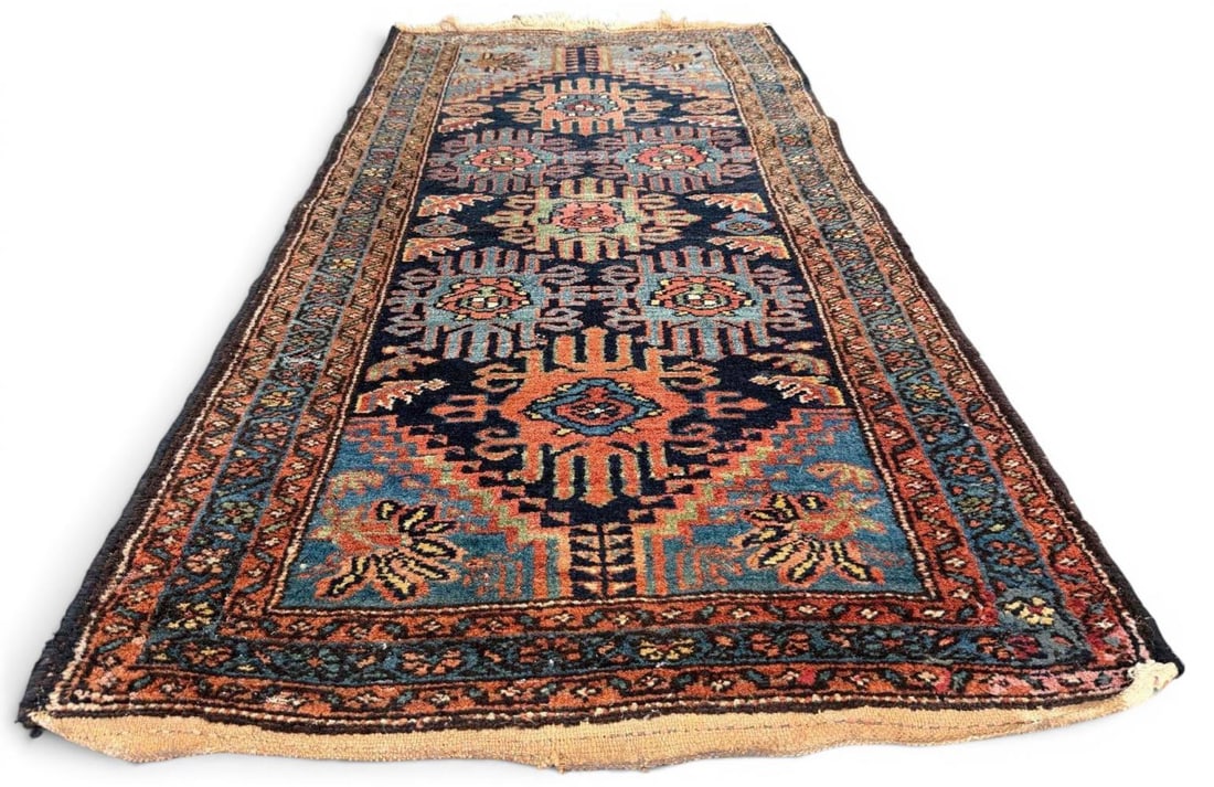 Older Hand Knotted Persian Tribal Rug: Older hand knotted Persian tribal rug with a geometric central medallion design, stylized floral and animal-like motifs, and multiple patterned borders in dark navy, rust, teal, salmon, and ivory tone