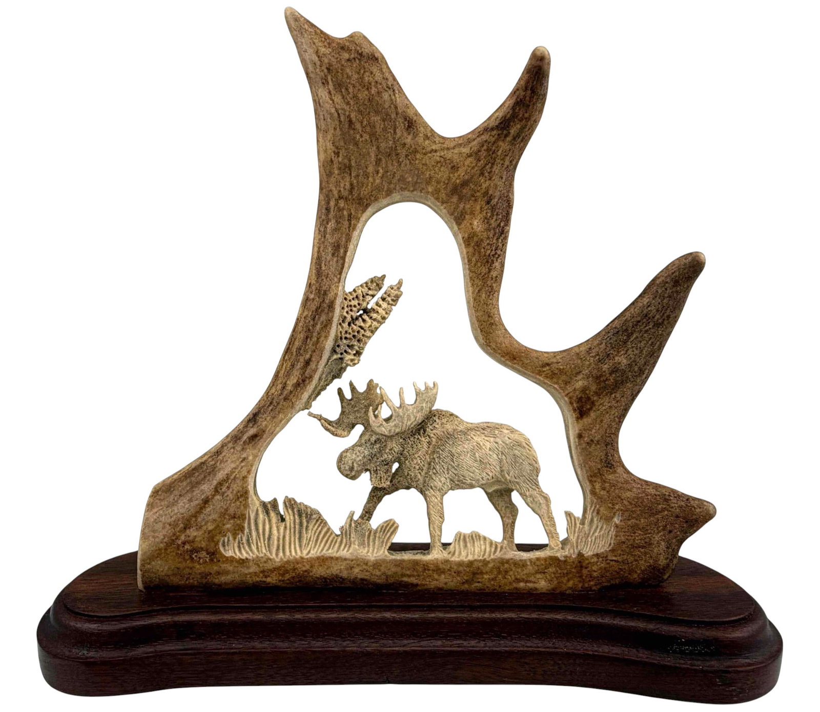Alaskan Carved Moose Antler Sculpture: Alaskan Carved Moose Antler Sculpture. Attached tag marked " Authentic Handicraft from Alaska." Approximately 7.37H x 8.37W x 2.12D in. Measurements include base.
