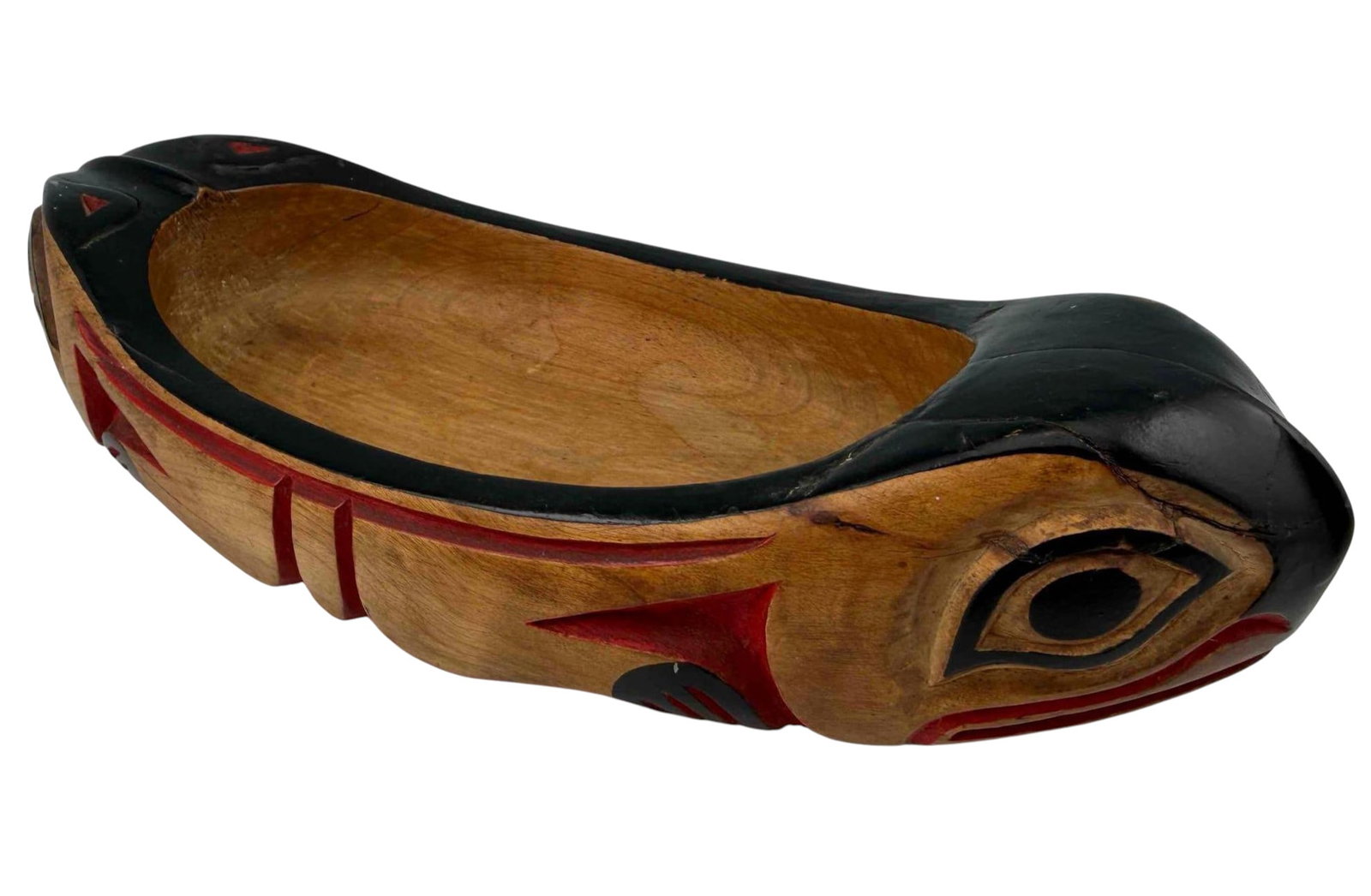 Northwest Coast Carved Wood Otter Feast Bowl: Carved and polychrome-painted alder wood feast bowl in the form of an otter with formline decoration in black and red. Attached tag at underside reads "NW Coast Otter Bowl." Please note repair at one 