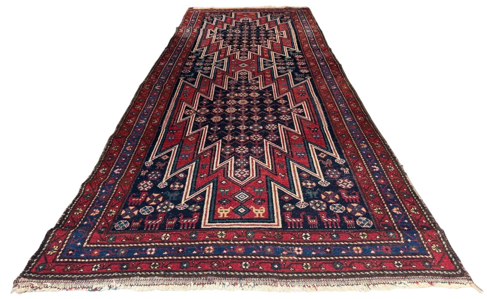 Persian Hamadan Region Runner Rug: Persian Hamadan Region Runner Rug. Hand-knotted wool runner with a dark field centered by a series of large serrated geometric medallions in red, navy, ivory, and blue, surrounded by small floral, ani