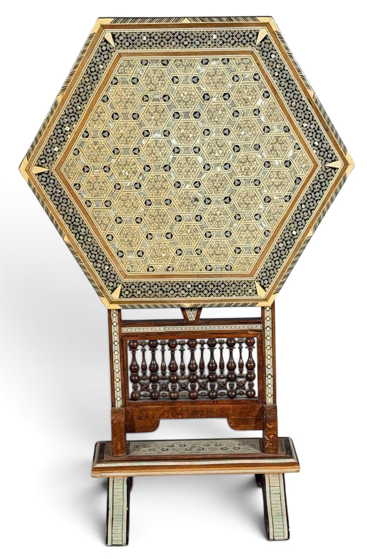 Syrian Inlaid Octagonal Tilt Top Table: Syrian Bone and Mother of Pearl Inlay Tilt Top Table. Approximately 24.0H x 19.62W x 17.0W in. (open). Approximately 30.5H x 19.62W x 11.oD in. (folded). Proceeds from this lot benefit Happy Dragon Th