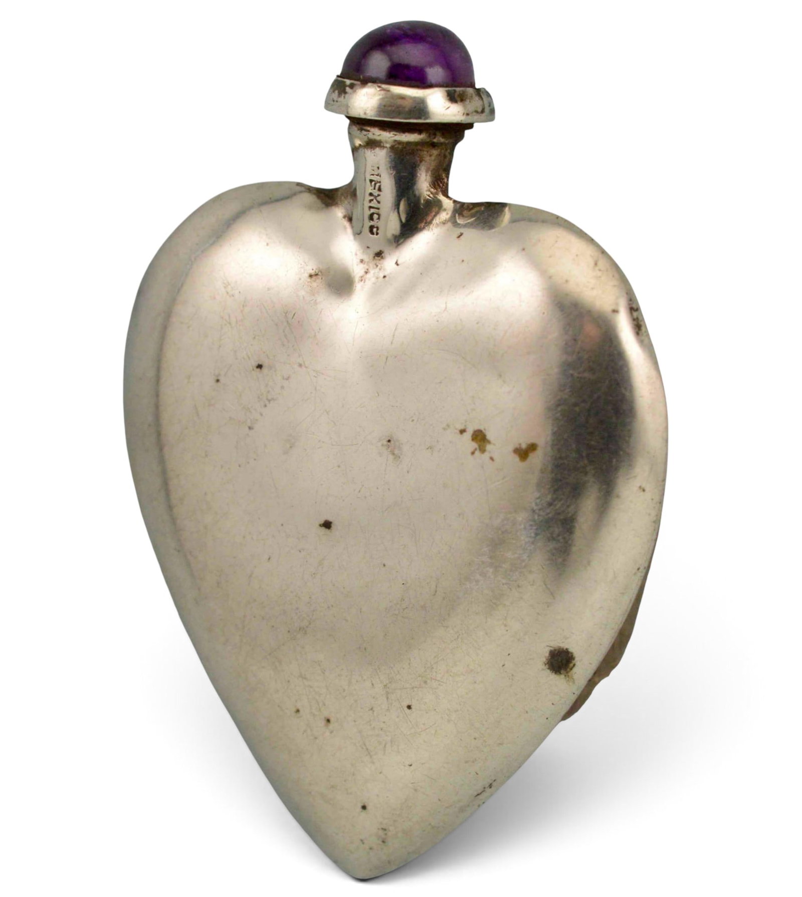 Sterling Silver Heart Form Perfume Bottle With Amethyst Stopper: Sterling Silver Amethyst Heart Shaped Perfume Bottle, 15.5g. Marked "SILVER MEXICO," tests as sterling. Approximately 2.25H x 1.62W in. ALL CREDIT CARDS WILL BE MANUALLY VERIFIED PRIOR TO SHIPMENT.