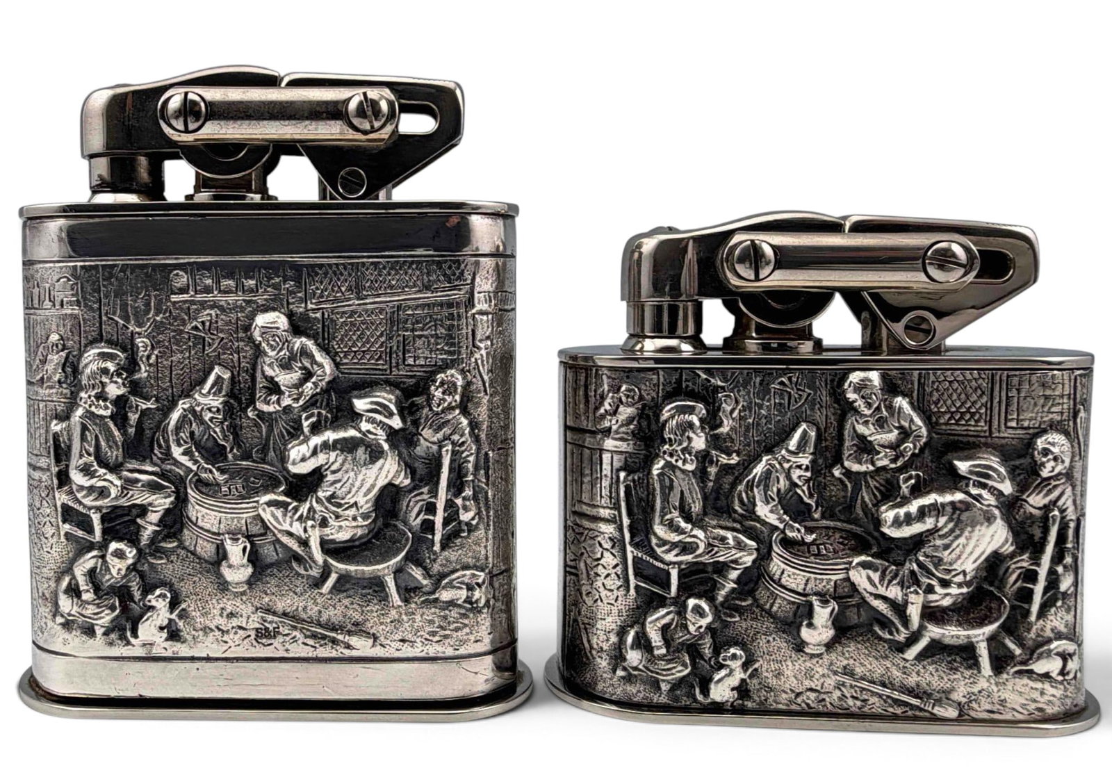 Two Continental Silver Plate Figural Table Lighters, Tavern Scene: Two Continental Silver Plate Figural Table Lighters, Tavern Scene. Cases marked "S&F." Undersides marked "KW." Approximately 4.0H x 3.25W x 1.25D in. and 3.0H x 3.25W x 1.25D in.