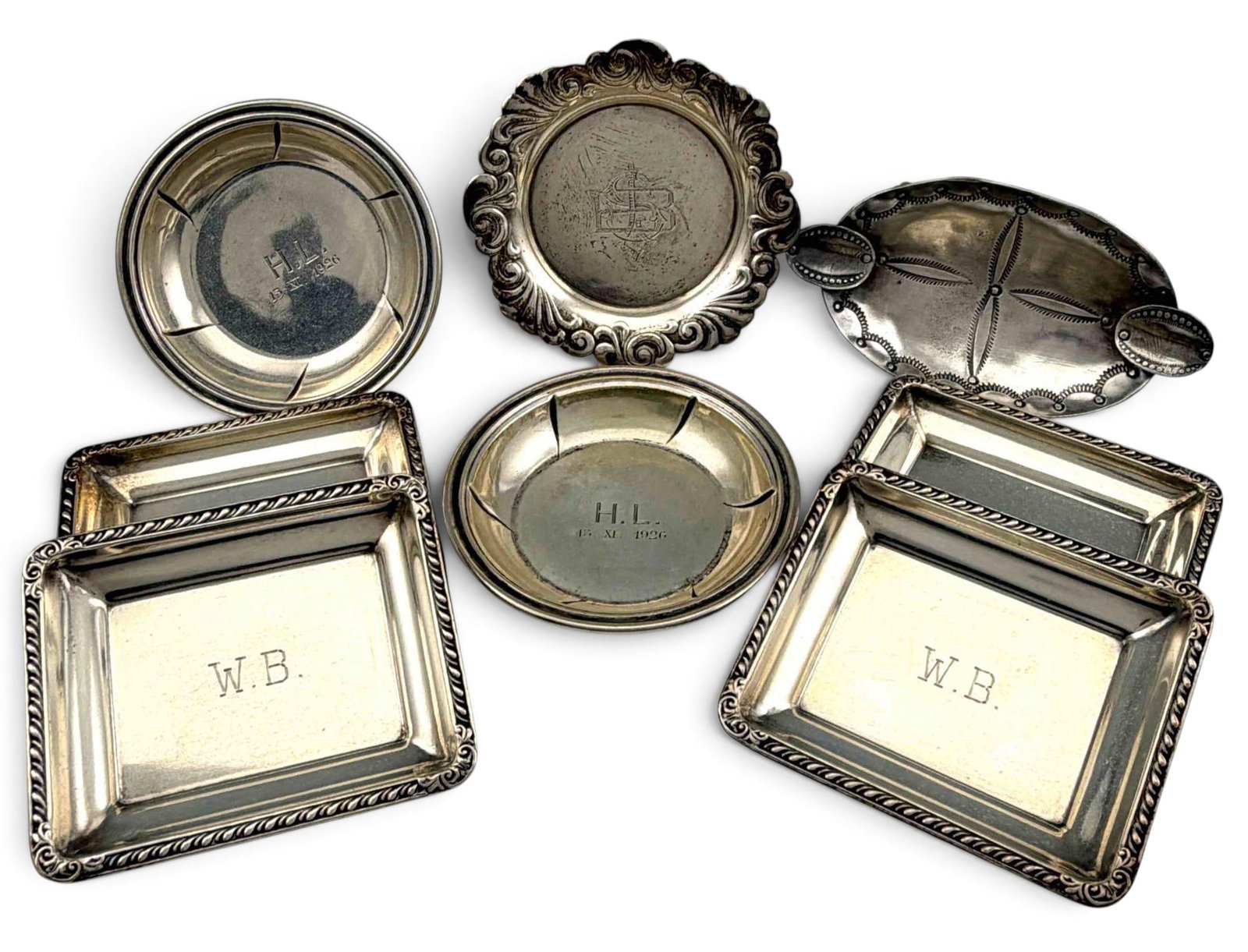 Grouping Of Small Silver Trays: Grouping Of Small Silver Trays. Sterling pieces 122.0g. German 800 silver trays 38.0g. Rectangular trays marked "Sterling 19345." Native American hand stamped ashtray unmarked, tests as sterling. Tray