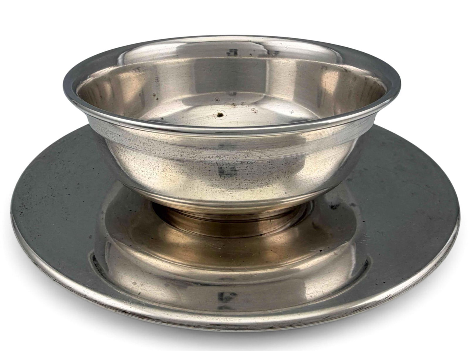 Handmade Sterling Silver Bowl & Saucer: Handmade Sterling Silver Bowl & Saucer, 284.4g. Marked "STERLING" and "MADE" within a hand-shaped cartouche. Bowl approximately 2.25H x 4.75W in. Saucer approximately 6.62in. ALL CREDIT CARDS WILL BE
