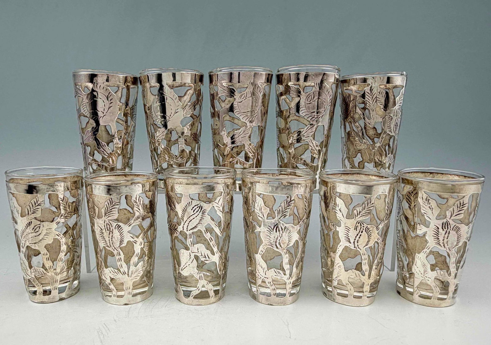 Set Of Mexican Sterling Silver Overlay Liquor Glasses: Mexican Sterling Silver Overlay Liquor Glasses, Set of Ten Plus One. Marked "Hecho en Mexico 0925." Approximately 2.5H x 1.5W in. ALL CREDIT CARDS WILL BE MANUALLY VERIFIED PRIOR TO SHIPMENT.