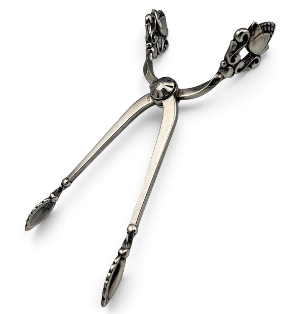 Georg Jensen Acorn Sterling Silver Sugar Tongs: Georg Jensen Acorn Sterling Silver Sugar Tongs, 26.8g. Marked "Sterling Denmark Georg Jensen." Approximately 3.62L x 0.62W in. ALL CREDIT CARDS WILL BE MANUALLY VERIFIED PRIOR TO SHIPMENT.
