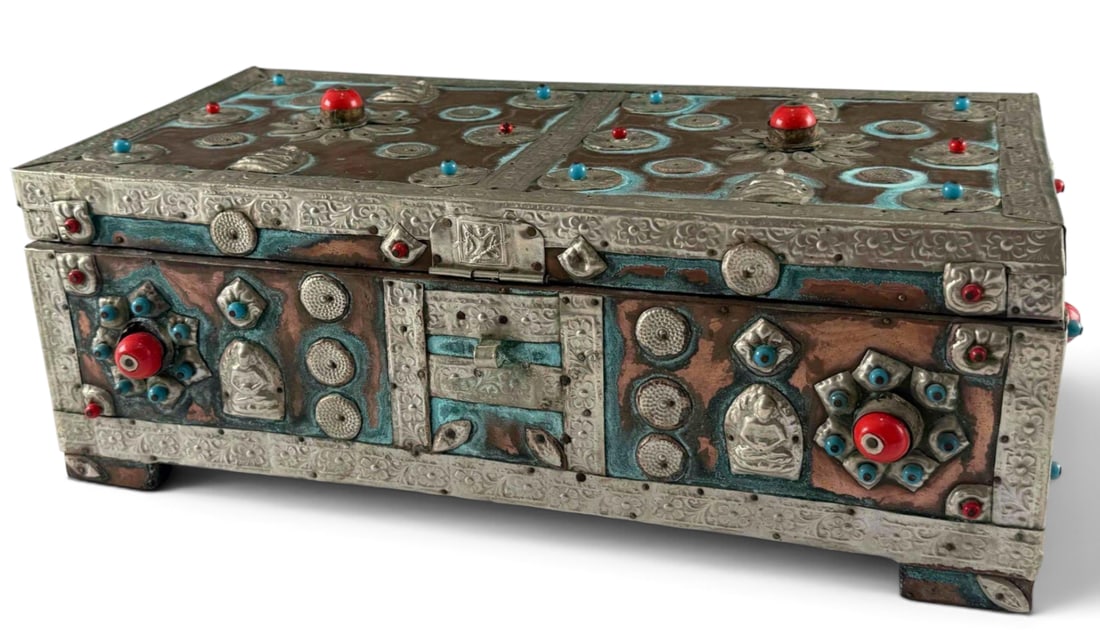 East Asian Trunk With Repousse Buddha Design, Blue & Red Glass Adornments: East Asian Trunk With Repousse Buddha Design, with Blue & Red Glass Adornments. Approximately 16.5W x 6.0H x 8.5D in.