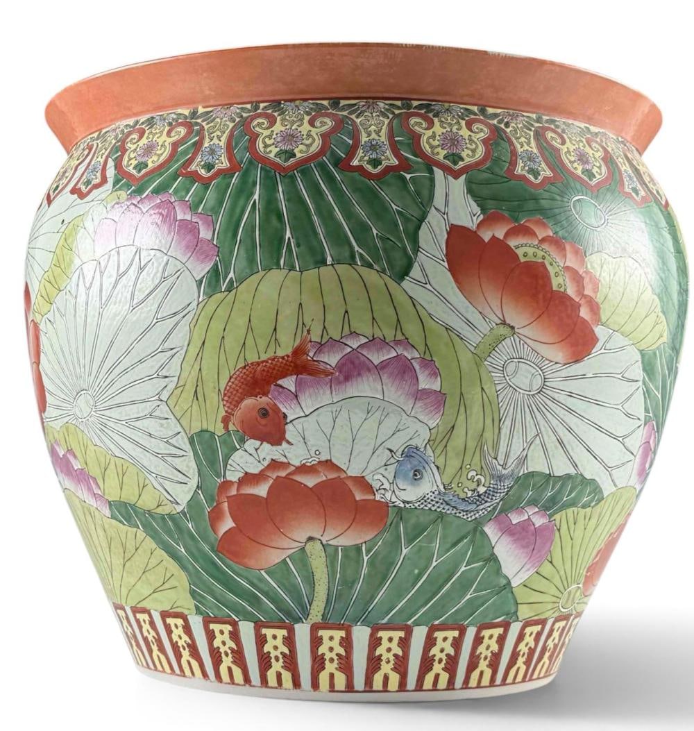 Large Chinese Famille Rose Porcelain Fish Bowl Jardiniere: Large Chinese famille rose porcelain fish bowl or jardiniere. Exterior decorated with a lotus pond scene of large lotus blossoms and leaves with fish and aquatic motifs, beneath a repeating floral bor