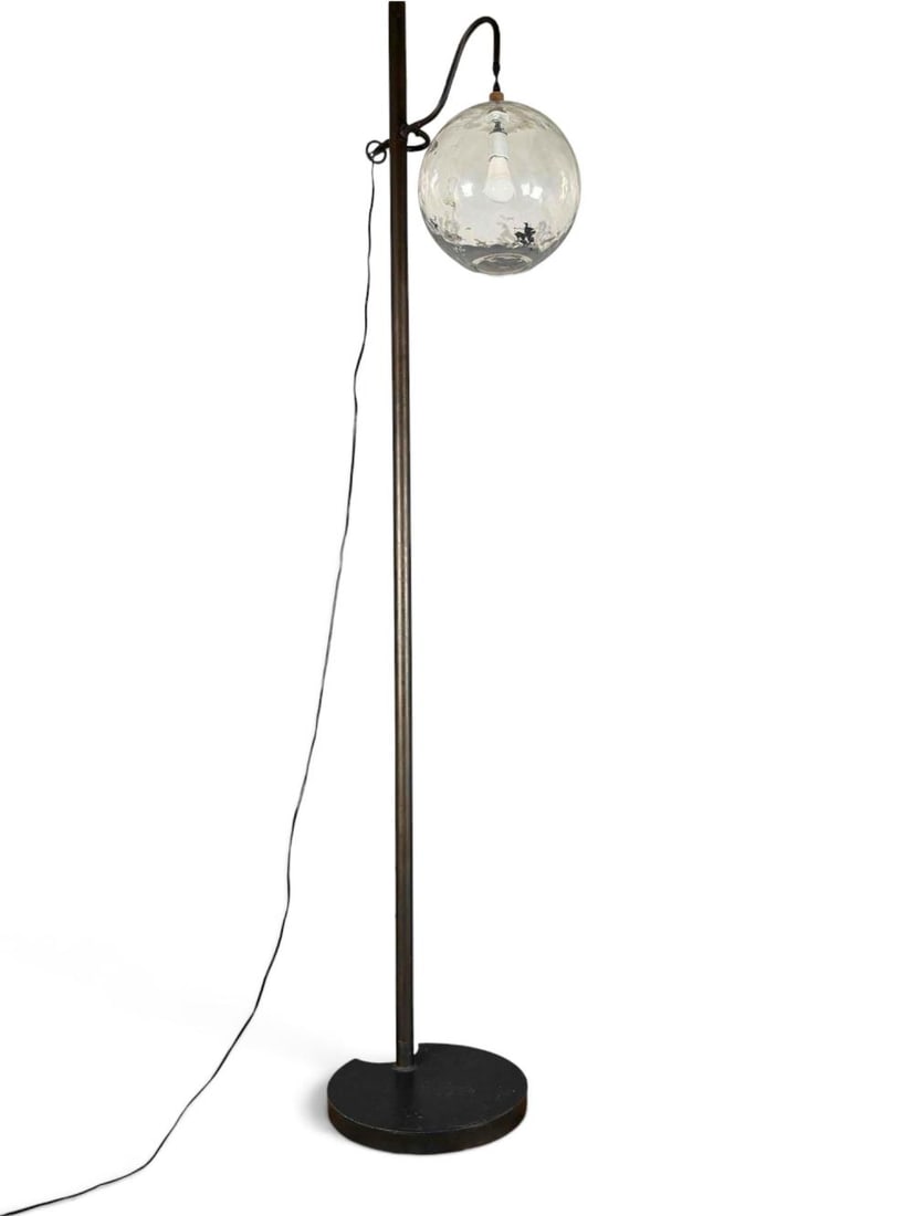 Contemporary Arched Globe Floor Lamp: Contemporary floor lamp with a tall arched black metal frame and suspended clear glass shade. Originally retailed as the "Aurora Floor Lamp" by TA Lorton, Tulsa. Measures approximately 92.0 H x 20.0W 